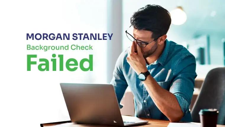 man sitting in depression near his laptop after failed background check
