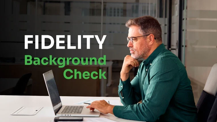 man in the office looking in laptop at his fidelity background check