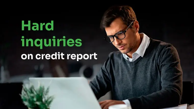 man sitting behind the laptop trying to remove inquiries on credit report
