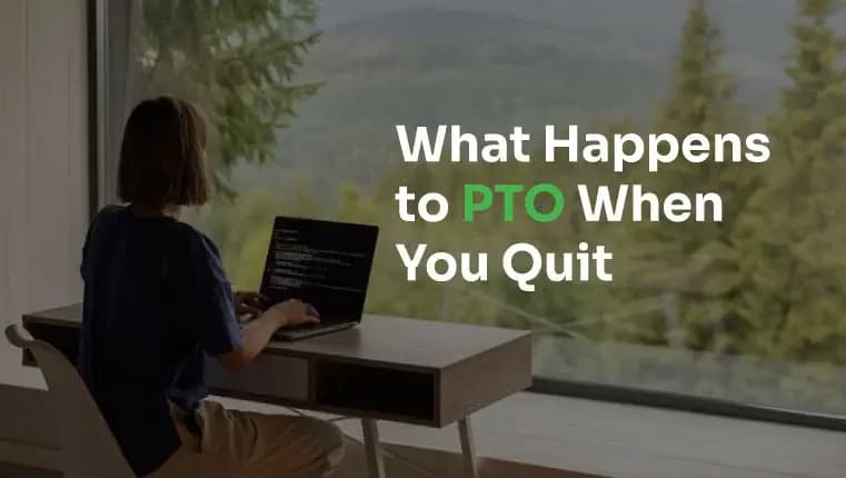 woman working behind her laptop in front of panoramic window