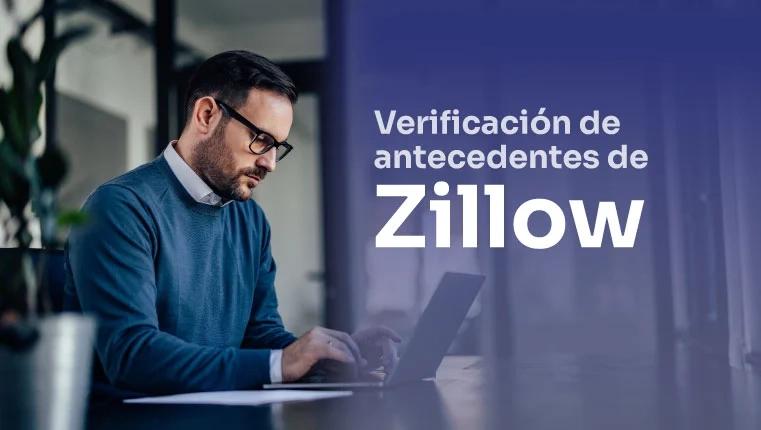 hombre en la oficina sentado en el laptop y revisando sus antecedentes en zillow