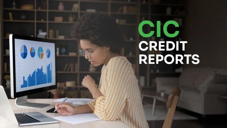 woman in glasses sitting behind the table and looking at her cic credit report