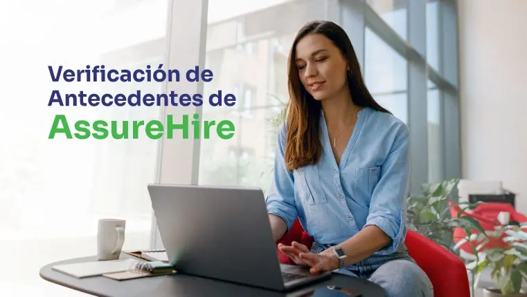 Mujer sentada en la silla roja mirando su computadora portátil