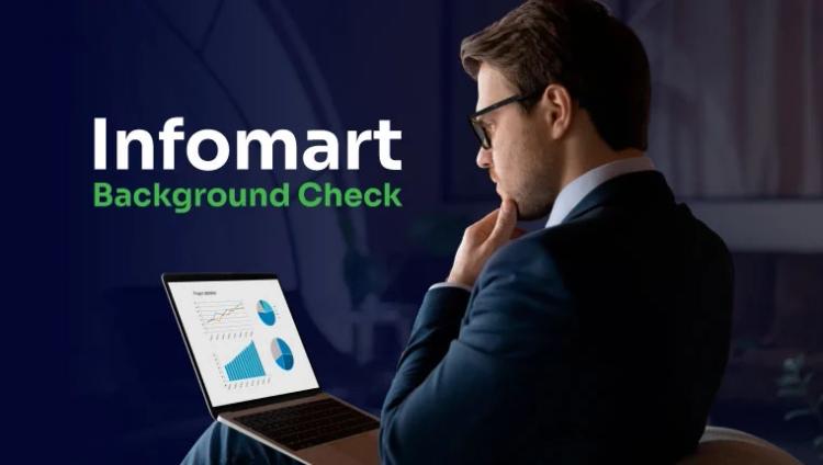 man looking in his laptop on his infomart background check