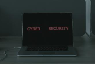 A laptop with the text "cyber security" on its monitor.