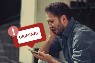 Man sees a criminal report on his phone.