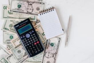 A calculator, a pen, and money.