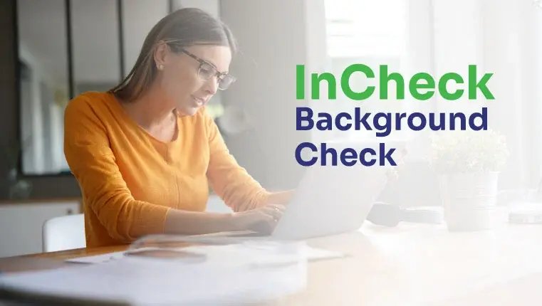 incheck background check woman in orange sweater working behind her laptop