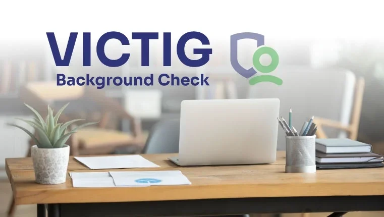 laptop laying on the table near victig background check