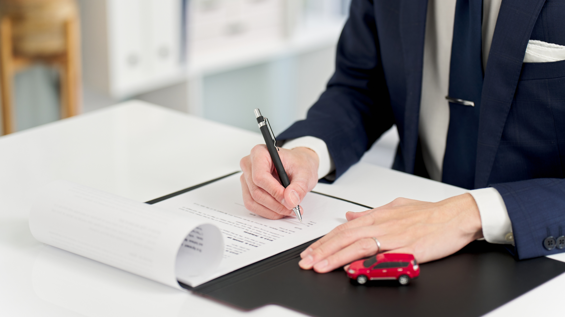 The insurance agent signs the documents.