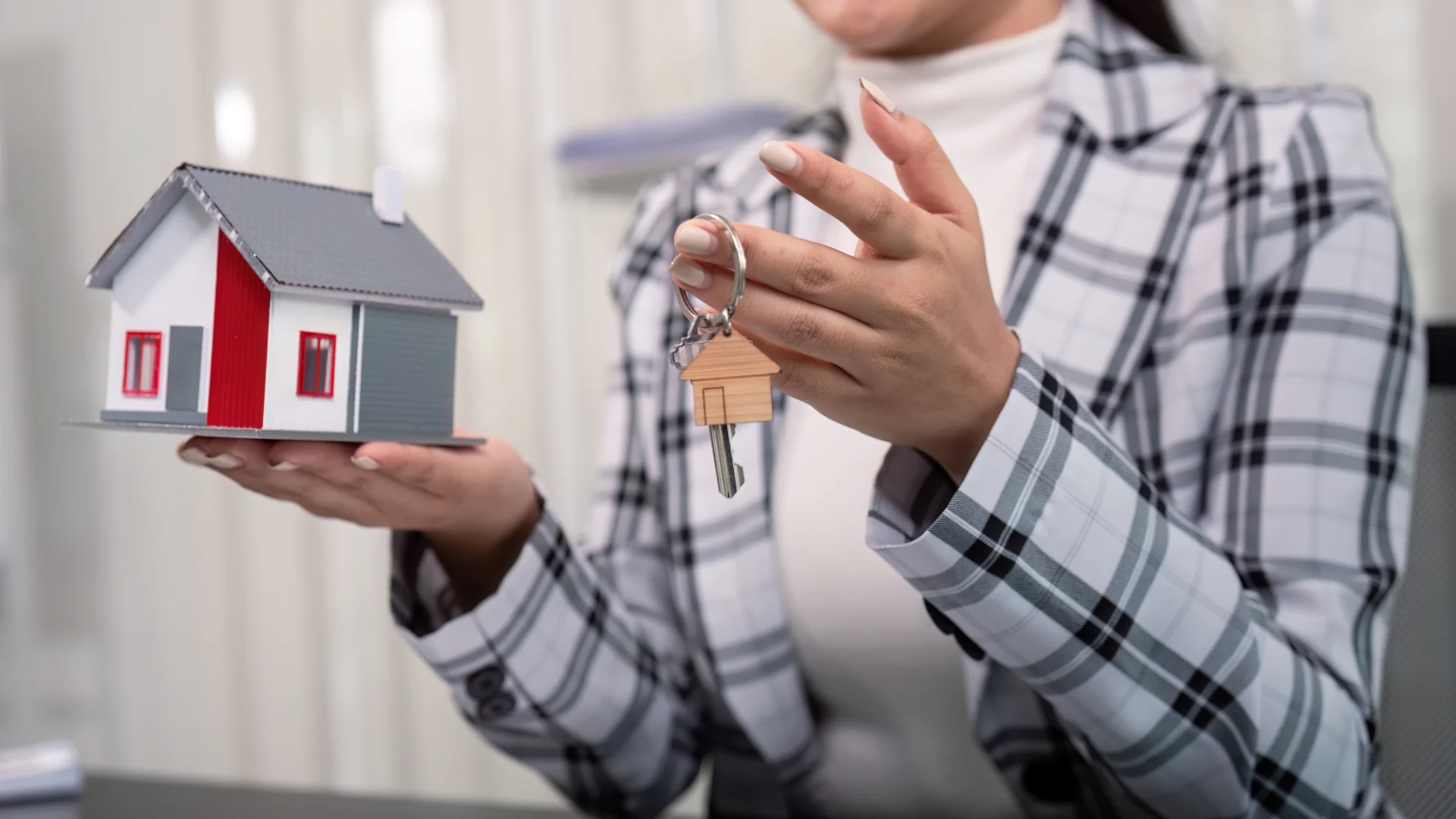 Mortgage Brokers: Help Clients Fix Credit Report Errors | Consumer Attorneys PLLС The woman holds the model house and the keys.